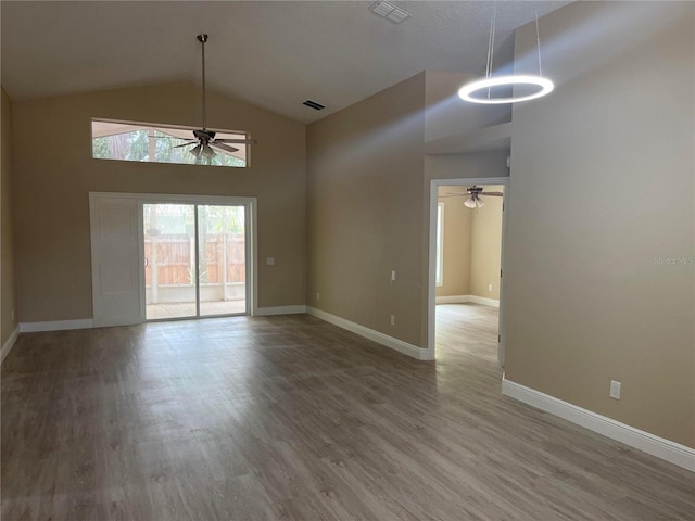 12421 Early Run Ln, Riverview, FL 33578 - spare room with a ceiling fan, high vaulted ceiling, wood finished floors, and baseboards