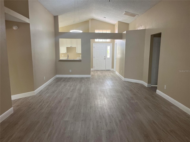 12421 Early Run Ln, Riverview, FL 33578 - entrance foyer with wood finished floors, a textured ceiling, baseboards, and high vaulted ceiling
