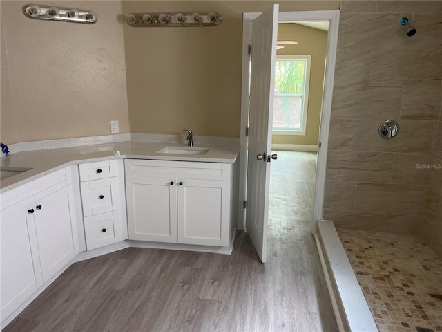 12421 Early Run Ln, Riverview, FL 33578 - bathroom with tiled shower, double vanity, and wood finished floors