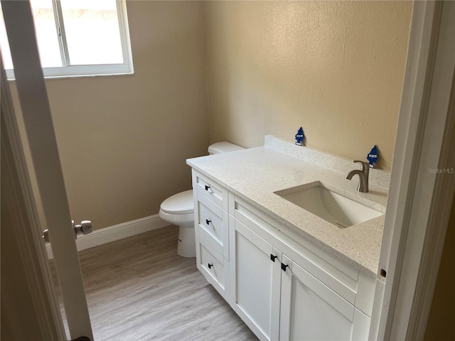 12421 Early Run Ln, Riverview, FL 33578 - half bath featuring toilet, vanity, wood finished floors, and baseboards