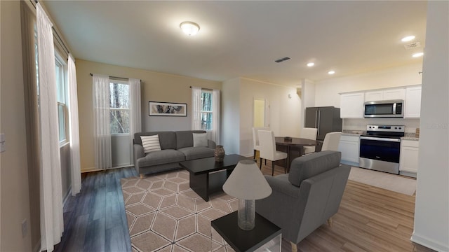 6166 Daerr Ridge St, Zephyrhills, FL 33542 - living room featuring light wood-type flooring, recessed lighting, and baseboards