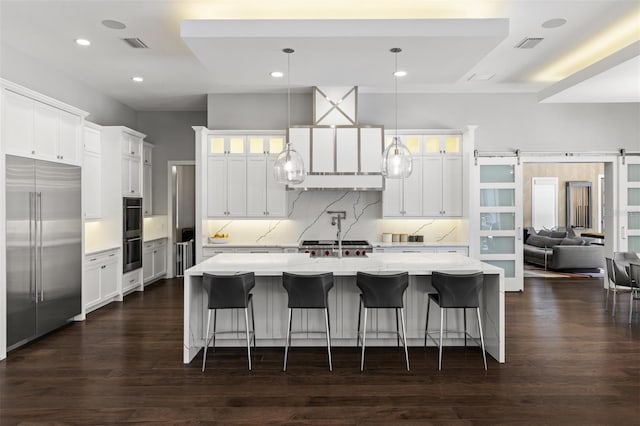 3428 Chaine Du Lac Blvd, Windermere, FL 34786 - kitchen featuring stainless steel built in refrigerator, glass insert cabinets, dark wood finished floors, backsplash, and a large island with sink