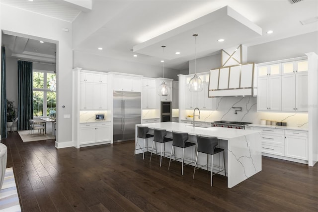 3428 Chaine Du Lac Blvd, Windermere, FL 34786 - kitchen with stainless steel built in refrigerator, dark wood finished floors, tasteful backsplash, a breakfast bar, and a spacious island