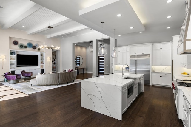 3428 Chaine Du Lac Blvd, Windermere, FL 34786 - kitchen with open floor plan, dark wood-style floors, light stone counters, white cabinetry, and built in appliances