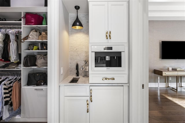3428 Chaine Du Lac Blvd, Windermere, FL 34786 - kitchen featuring wood finished floors, white cabinetry, light countertops, and decorative light fixtures