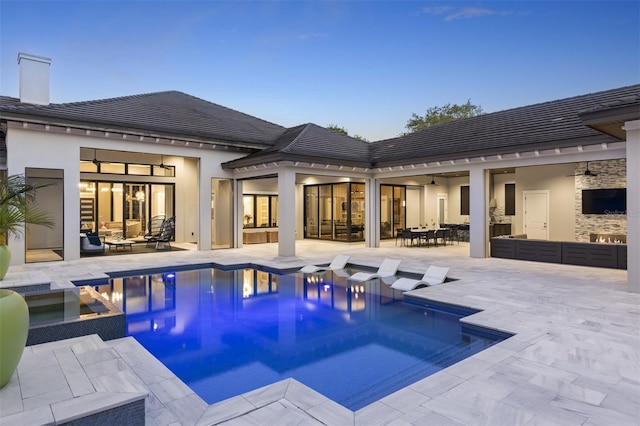 3428 Chaine Du Lac Blvd, Windermere, FL 34786 - back of property featuring outdoor dining space, an outdoor hangout area, a pool with connected hot tub, and a patio area