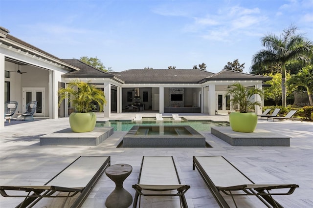 3428 Chaine Du Lac Blvd, Windermere, FL 34786 - rear view of house featuring french doors, a patio, an outdoor pool, and an in-ground hot tub