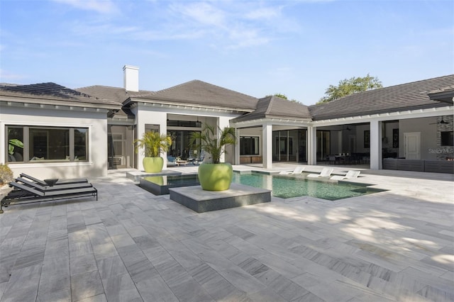 3428 Chaine Du Lac Blvd, Windermere, FL 34786 - rear view of property with ceiling fan, a chimney, a patio, an outdoor pool, and a tiled roof