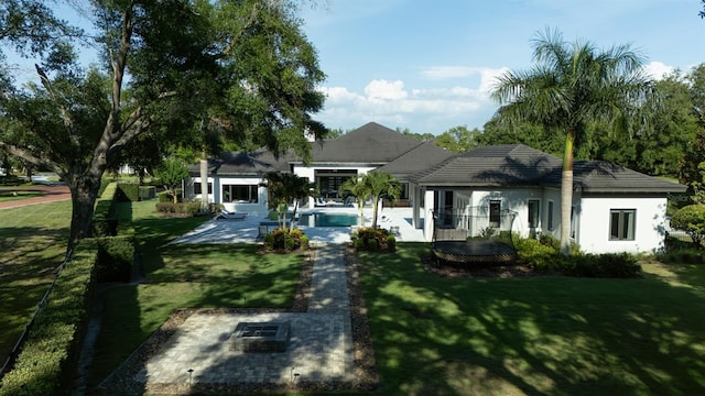 3428 Chaine Du Lac Blvd, Windermere, FL 34786 - view of front facade featuring a front yard, an outdoor pool, and stucco siding
