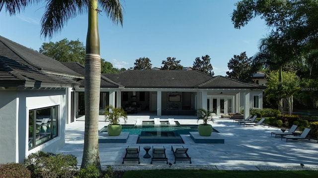 3428 Chaine Du Lac Blvd, Windermere, FL 34786 - back of house featuring french doors, a patio, an outdoor pool, and stucco siding