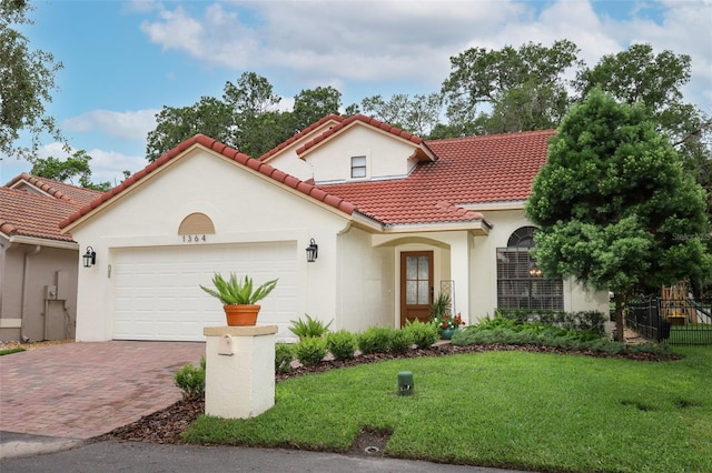 1364 Augusta National Blvd, Winter Springs, FL 32708 - mediterranean / spanish home with stucco siding, an attached garage, decorative driveway, and a tiled roof