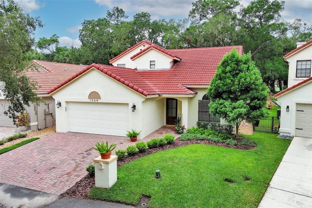 1364 Augusta National Blvd, Winter Springs, FL 32708 - mediterranean / spanish house with a tile roof, stucco siding, decorative driveway, and a garage