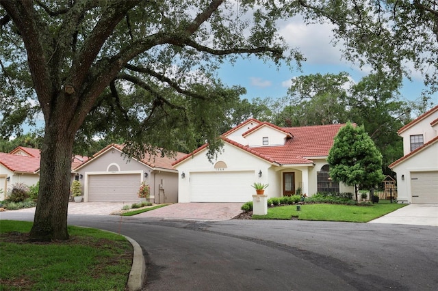 1364 Augusta National Blvd, Winter Springs, FL 32708 - mediterranean / spanish-style home featuring a tile roof, stucco siding, a front yard, and driveway