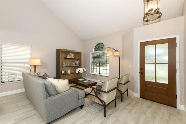 1364 Augusta National Blvd, Winter Springs, FL 32708 - living room with light wood-type flooring, baseboards, high vaulted ceiling, and a chandelier