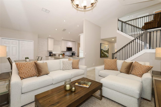 1364 Augusta National Blvd, Winter Springs, FL 32708 - living room featuring stairway, a chandelier, baseboards, high vaulted ceiling, and recessed lighting