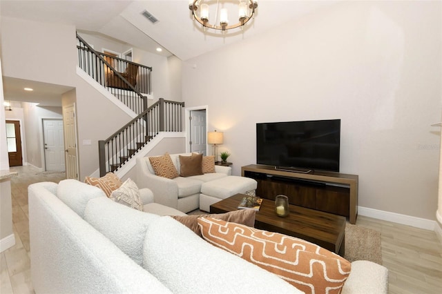 1364 Augusta National Blvd, Winter Springs, FL 32708 - living room with a chandelier, stairs, baseboards, high vaulted ceiling, and wood finished floors