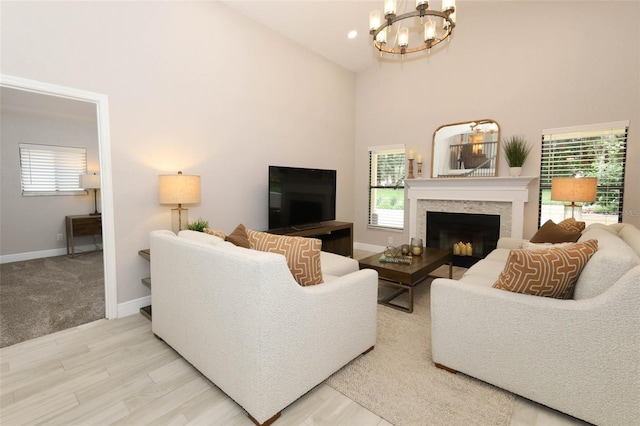 1364 Augusta National Blvd, Winter Springs, FL 32708 - living area featuring a high ceiling, a chandelier, baseboards, a fireplace, and healthy amount of natural light