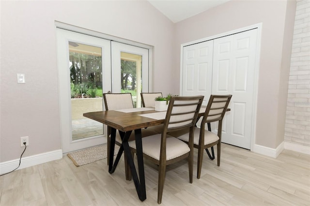 1364 Augusta National Blvd, Winter Springs, FL 32708 - dining space featuring french doors, baseboards, light wood-style floors, and vaulted ceiling