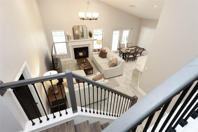 1364 Augusta National Blvd, Winter Springs, FL 32708 - stairway featuring high vaulted ceiling, a chandelier, a tiled fireplace, and wood finished floors
