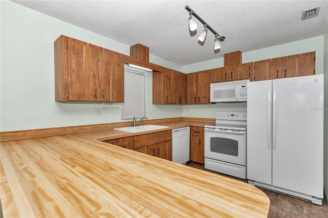 6421 NW 61st St, Ocala, FL 34482 - kitchen with white appliances, a sink, light countertops, brown cabinetry, and a textured ceiling