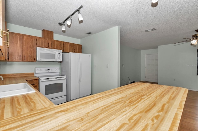 6421 NW 61st St, Ocala, FL 34482 - kitchen featuring white appliances, a sink, wooden counters, a textured ceiling, and ceiling fan