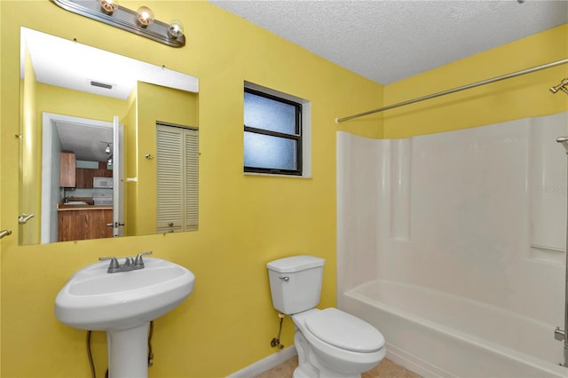 6421 NW 61st St, Ocala, FL 34482 - bathroom with a textured ceiling,  shower combination, toilet, and baseboards