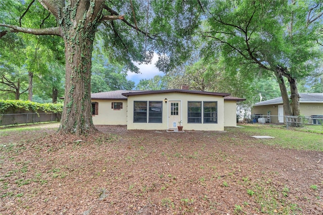 6421 NW 61st St, Ocala, FL 34482 - back of property with a fenced backyard, stucco siding, and a chimney