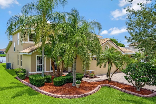 2631 Captains Ct, Kissimmee, FL 34746 - view of front facade with a tile roof, stucco siding, driveway, a front lawn, and a garage