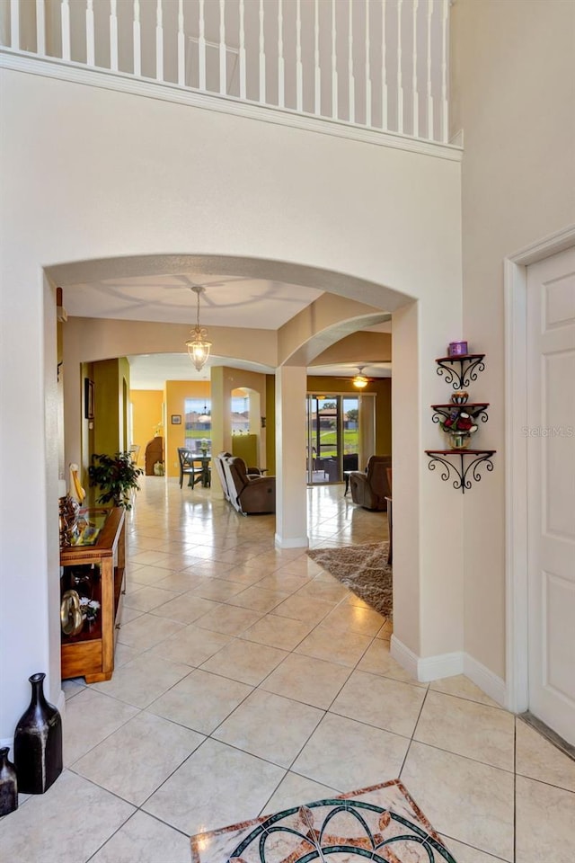 2631 Captains Ct, Kissimmee, FL 34746 - hallway featuring arched walkways, light tile patterned flooring, and a towering ceiling