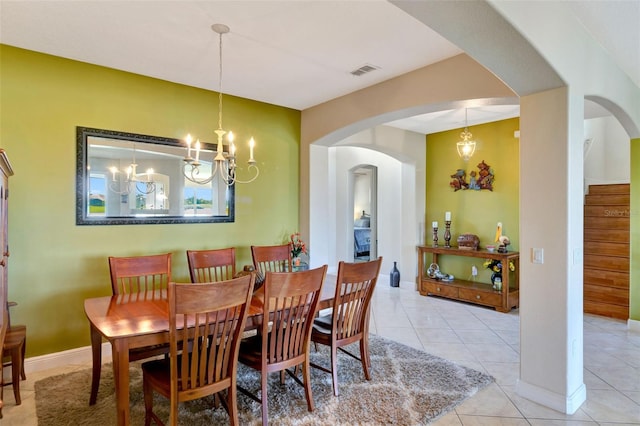 2631 Captains Ct, Kissimmee, FL 34746 - tiled dining room featuring a chandelier and arched walkways