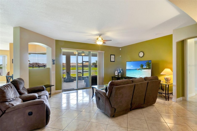 2631 Captains Ct, Kissimmee, FL 34746 - living area featuring ceiling fan, plenty of natural light, arched walkways, and light tile patterned flooring