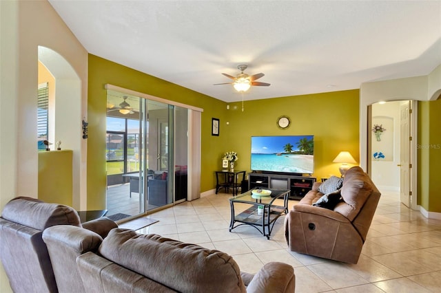 2631 Captains Ct, Kissimmee, FL 34746 - living room featuring arched walkways, a ceiling fan, and light tile patterned floors
