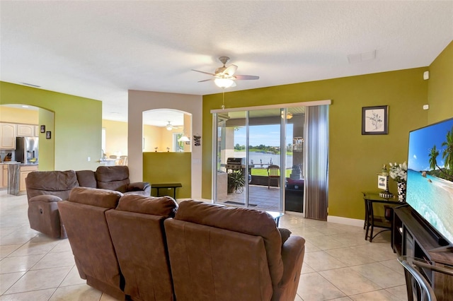 2631 Captains Ct, Kissimmee, FL 34746 - living area with arched walkways, ceiling fan, and light tile patterned floors