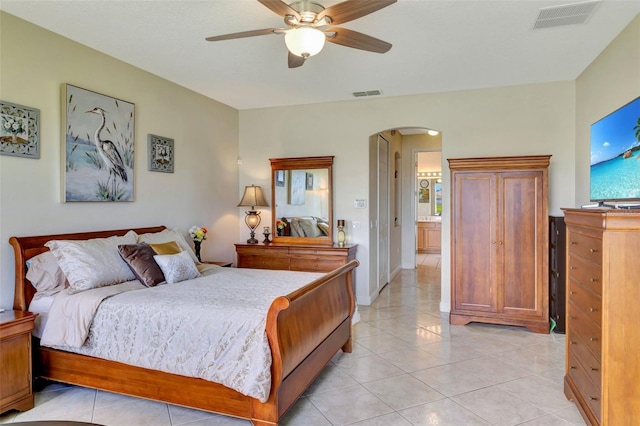 2631 Captains Ct, Kissimmee, FL 34746 - bedroom featuring arched walkways, light tile patterned floors, and a ceiling fan