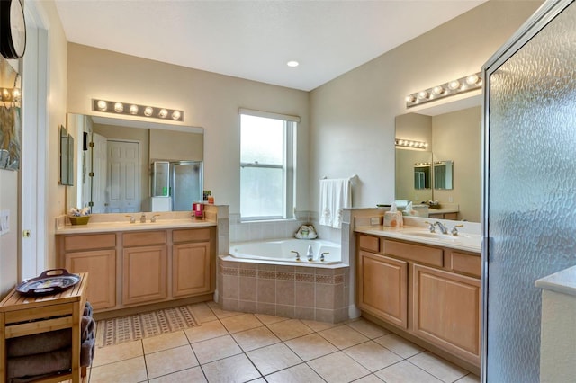 2631 Captains Ct, Kissimmee, FL 34746 - full bathroom featuring tile patterned flooring, a bath, a stall shower, and two vanities