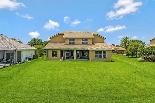 2631 Captains Ct, Kissimmee, FL 34746 - back of property featuring a tile roof, a yard, and stucco siding