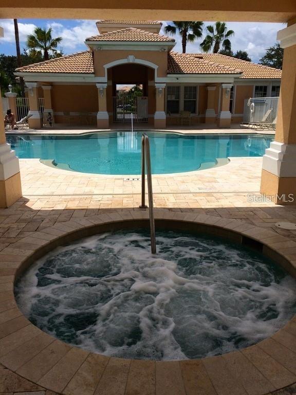 13512 Turtle Marsh Loop Unit 729, Orlando, FL 32837 - community pool featuring a hot tub and a patio
