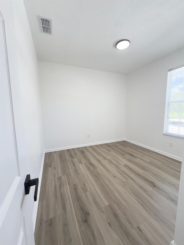 13512 Turtle Marsh Loop Unit 729, Orlando, FL 32837 - unfurnished room featuring wood finished floors, baseboards, and a textured ceiling