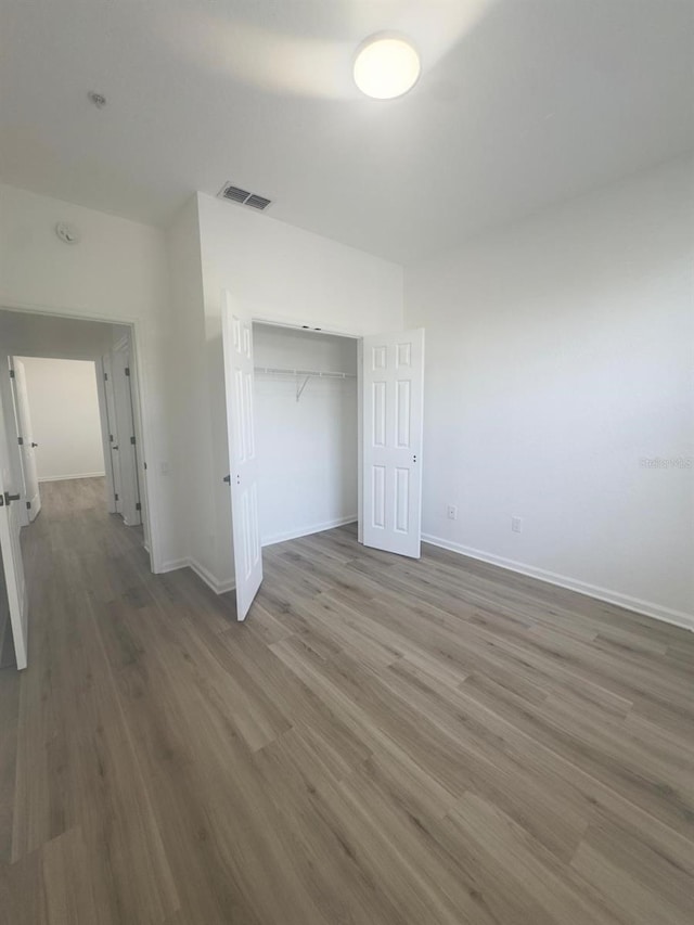 13512 Turtle Marsh Loop Unit 729, Orlando, FL 32837 - unfurnished bedroom featuring wood finished floors, baseboards, and a closet