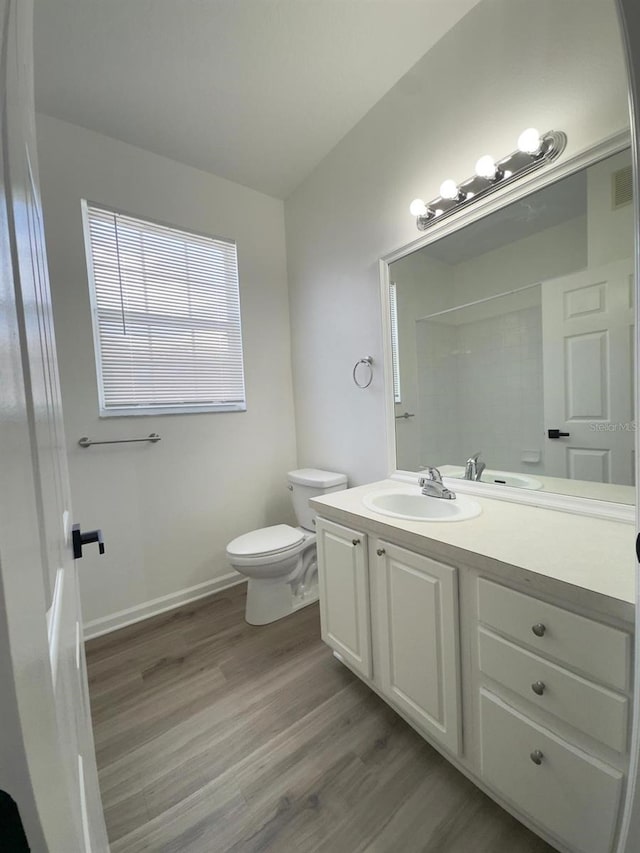 13512 Turtle Marsh Loop Unit 729, Orlando, FL 32837 - bathroom with vanity, wood finished floors, toilet, a shower, and baseboards