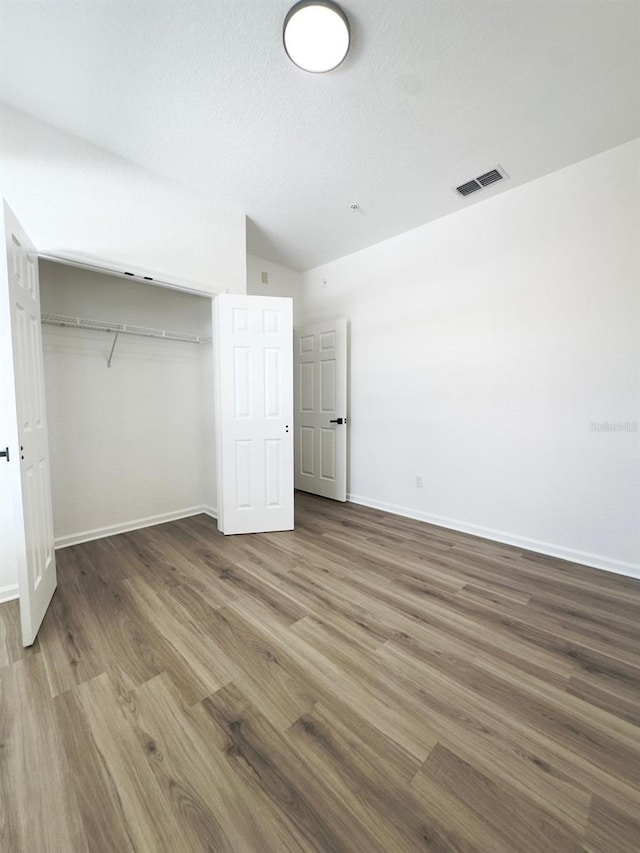 13512 Turtle Marsh Loop Unit 729, Orlando, FL 32837 - unfurnished bedroom with wood finished floors, baseboards, and a closet