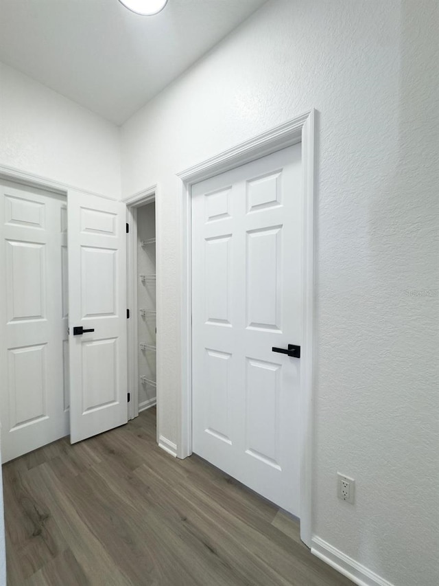 13512 Turtle Marsh Loop Unit 729, Orlando, FL 32837 - corridor featuring dark wood-style flooring, baseboards, and a textured wall