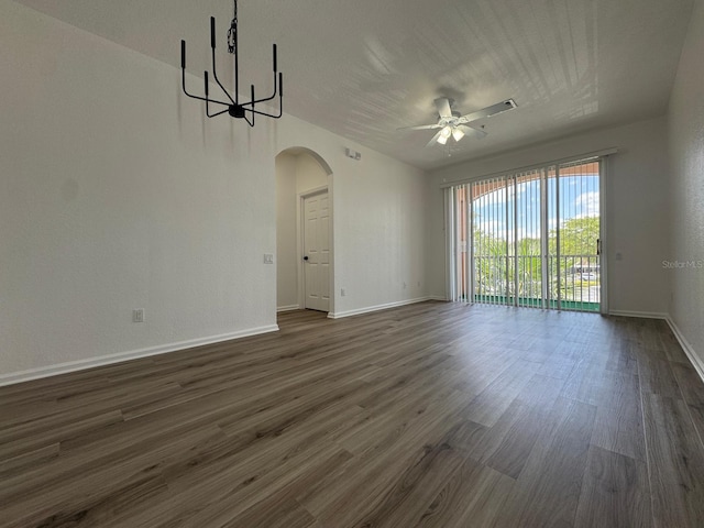 13512 Turtle Marsh Loop Unit 729, Orlando, FL 32837 - unfurnished room featuring arched walkways, a ceiling fan, baseboards, and dark wood-type flooring