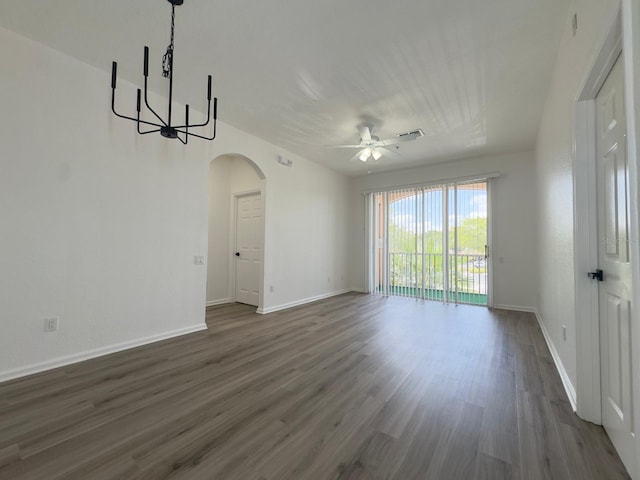 13512 Turtle Marsh Loop Unit 729, Orlando, FL 32837 - empty room featuring arched walkways, dark wood-style floors, ceiling fan, baseboards, and a chandelier