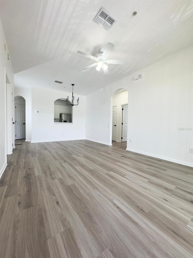 13512 Turtle Marsh Loop Unit 729, Orlando, FL 32837 - unfurnished living room featuring arched walkways, ceiling fan, wood finished floors, and baseboards