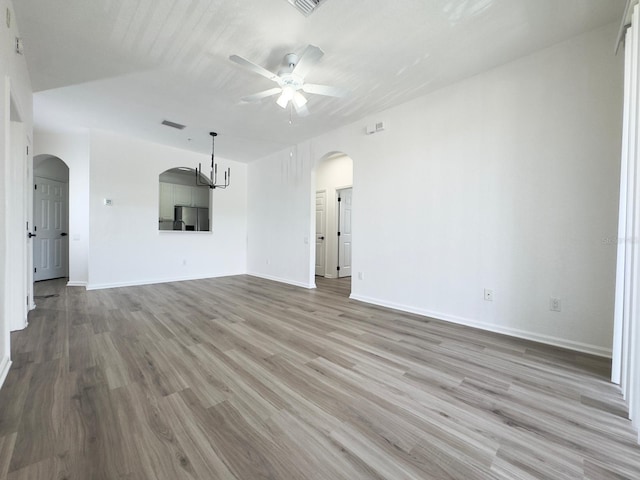 13512 Turtle Marsh Loop Unit 729, Orlando, FL 32837 - unfurnished living room featuring arched walkways, a ceiling fan, light wood finished floors, and baseboards