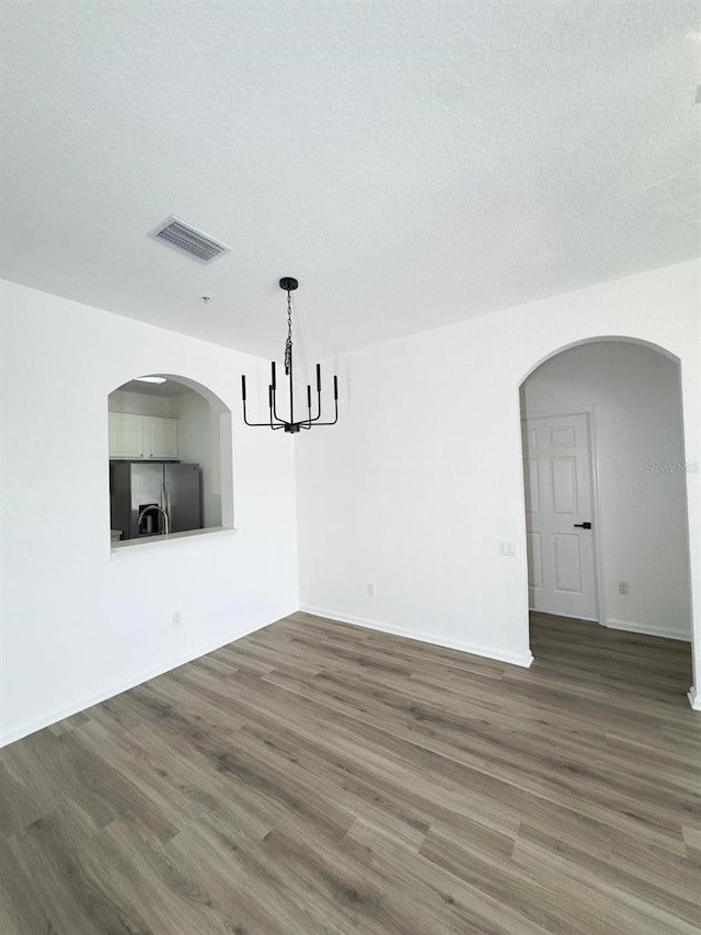 13512 Turtle Marsh Loop Unit 729, Orlando, FL 32837 - unfurnished dining area with wood finished floors, a chandelier, arched walkways, and baseboards