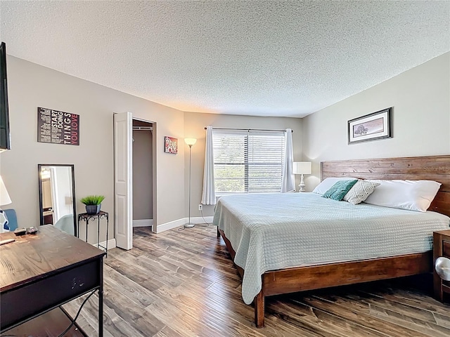 3944 Atrium Dr Unit 4, Orlando, FL 32822 - bedroom featuring wood finished floors, a textured ceiling, and baseboards