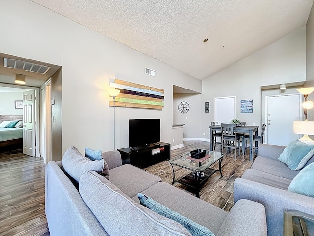 3944 Atrium Dr Unit 4, Orlando, FL 32822 - living area featuring wood finished floors, baseboards, and high vaulted ceiling