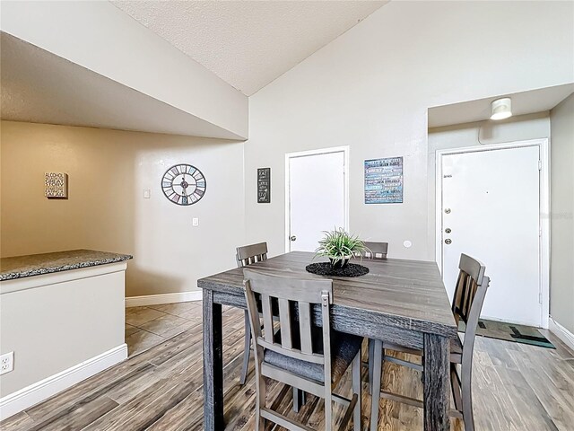 3944 Atrium Dr Unit 4, Orlando, FL 32822 - dining space featuring wood finished floors, lofted ceiling, and baseboards